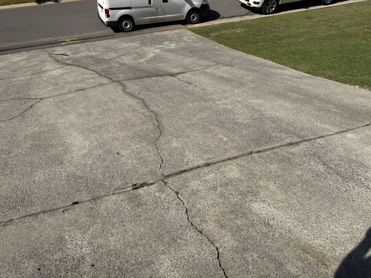 Before - Concrete driveway pressure washing with visible dirt and buildup
